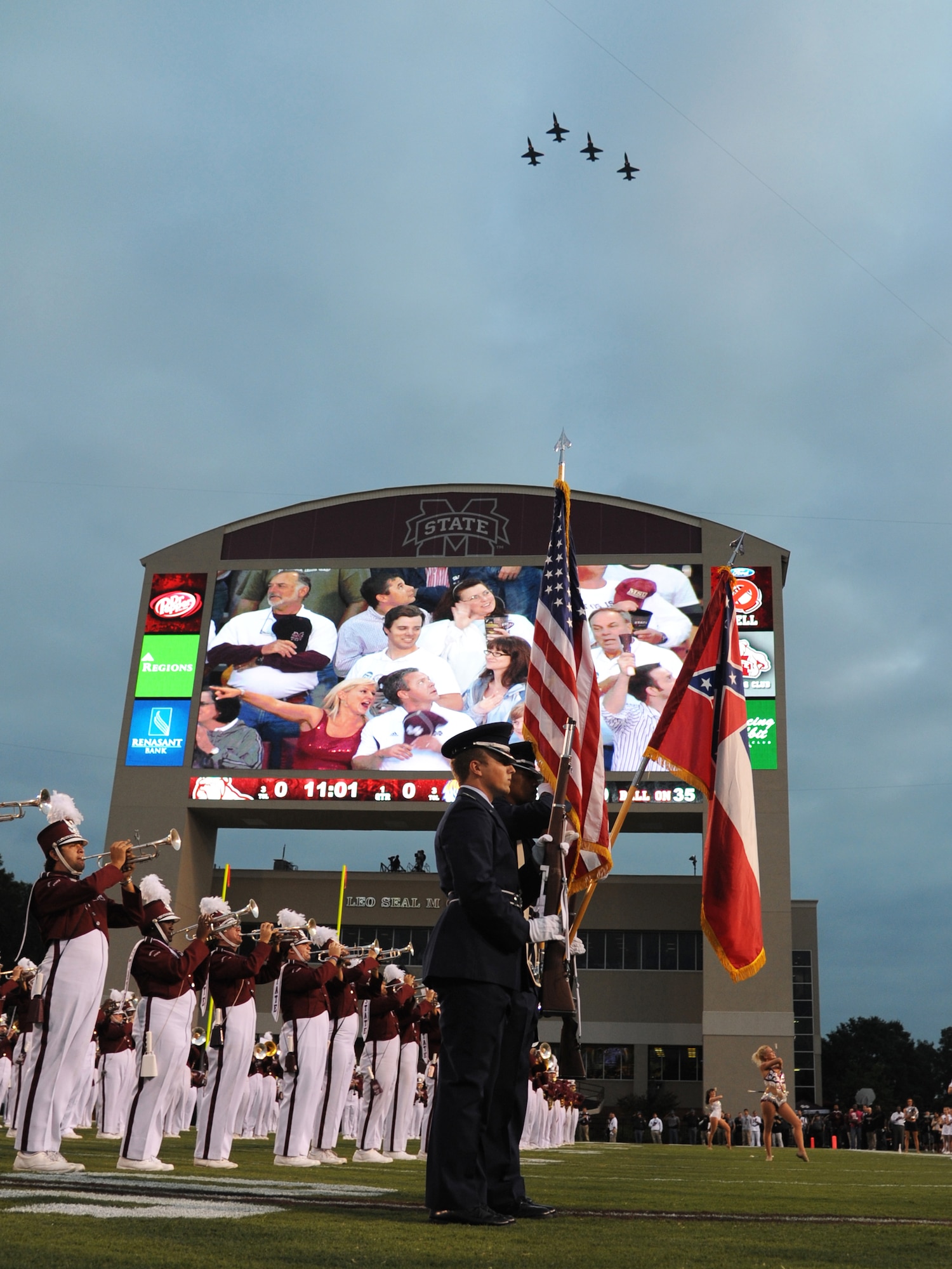 A four-ship formation of T-38C Talons from Columbus Air Force Base fly over the Mississippi State University Stadium as the MSU marching band plays the last note of the national anthem Sept. 15. Piloting the formation are: Lt. Col. Joseph Speed, 14th Operations Support Squadron Commander, Lt. Col. Robert Haas, 50th Flying Training Squadron Commander, Lt. Col. Rob Skelton, 14th Flying Training Wing and 1st Lt. Stephen McNamara, 50th FTS. Speed and Haas also earned degrees at MSU. (U.S. Air Force photo/Airman 1st Class Chase Hedrick)