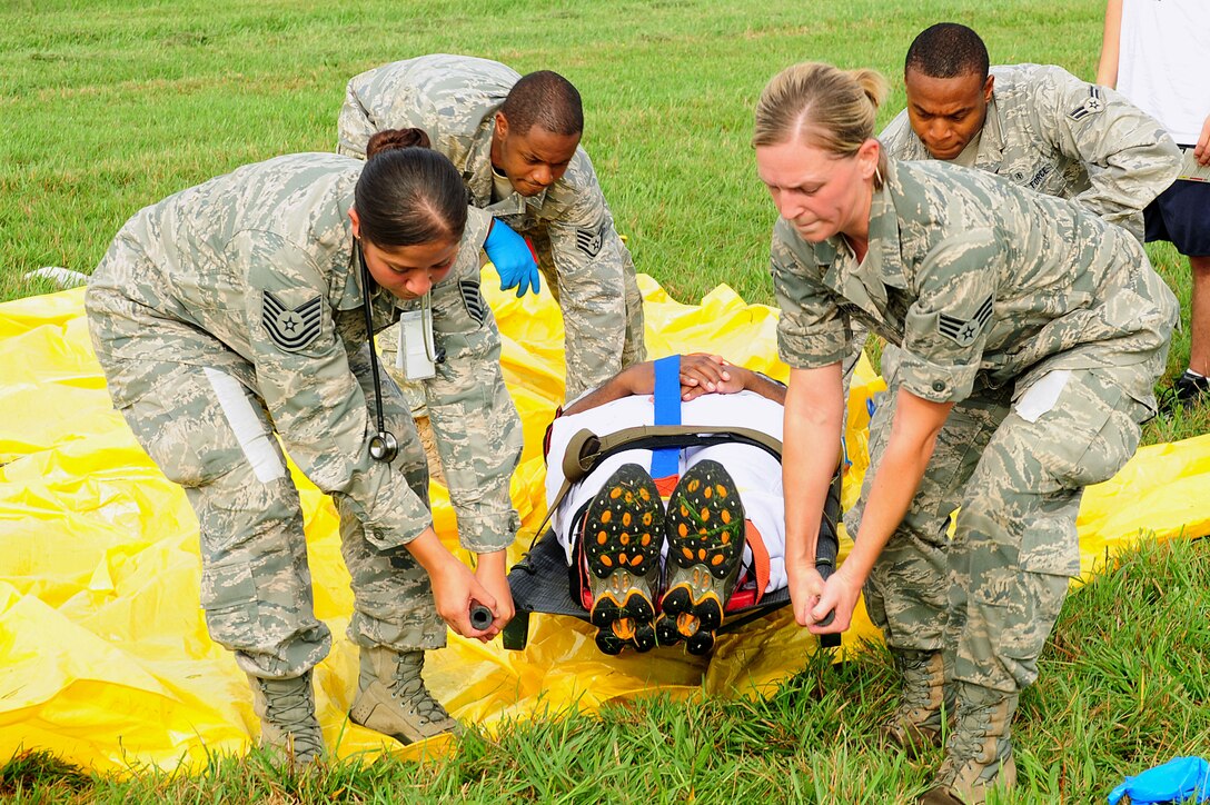 Members of the 633rd Air Base Wing Medical Group prepare to carry an injured individual as part of a mass casualty exercise at Langley Air Force Base, Va., Sept. 22, 2011. The reason for the exercise was to test the preparedness of Langley AFB and improve its ability to respond to emergency situations.  (U.S. Air Force photo by Airman 1st Class Kayla Newman/Released)