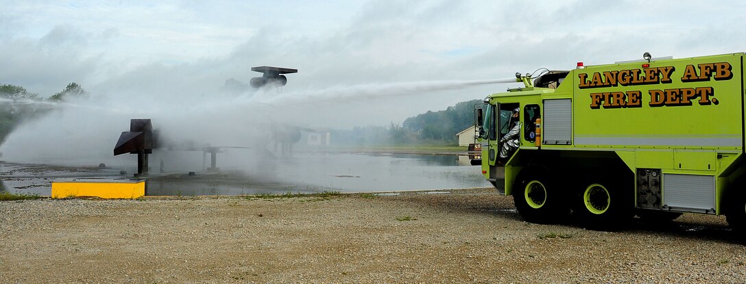 Members of the 633rd Air Base Wing Civil Engineer Squadron put out a simulated, plane-crash fire during a major accident response exercise at Langley Air Force Base, Va., Sept. 22, 2011.  The reason for the exercise was to advance the base’s preparedness and assess its ability to respond to emergency situations.  (U.S. Air Force photo by Airman 1st Class Kayla Newman/Released)