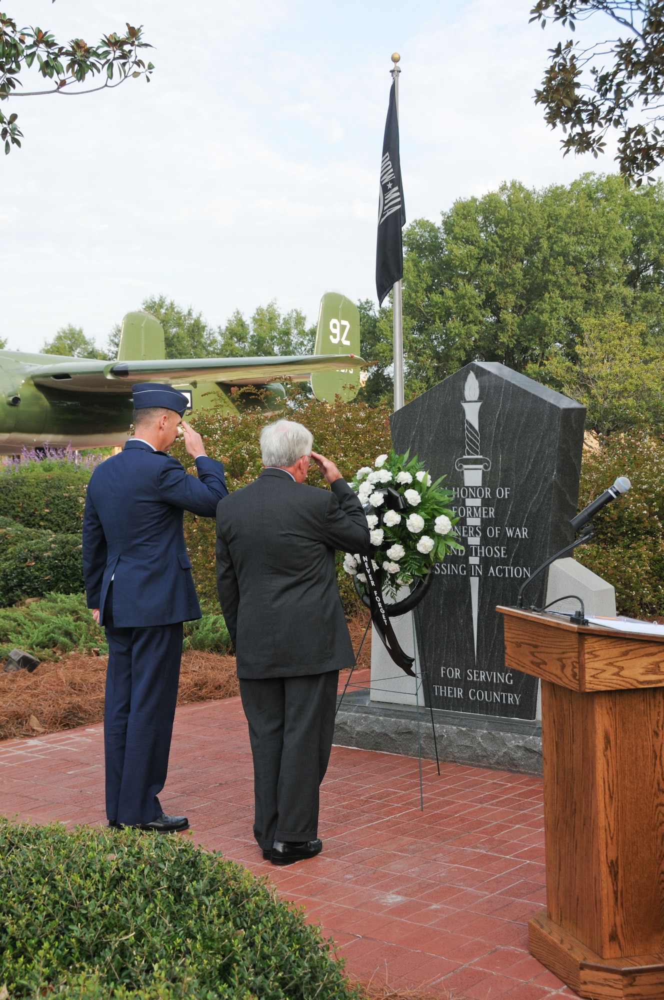 From left, Col. Brian Killough, 42nd Air Base Wing commander, and Hank Fowler, Vietnam-era prisoner of war, pay tribute to prisoners of war and service members still missing in action during a ceremony at Maxwell's Air Park Monday. (Air Force photo/Chris Baldwin)