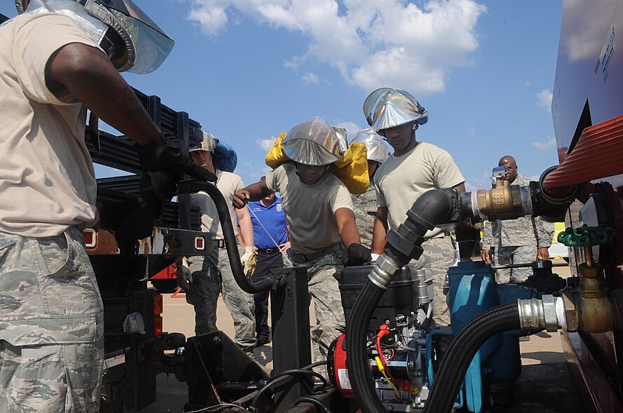 Airmen watch as Airman 1st Class Marlon Johnson, 2nd Civil Engineer Squadron Fire Department tail board, starts a foam trailer during egress training on Barksdale Air Force Base, La., Sept. 21. Aqueos film forming foam is used to extinguish fuel spills. (U.S. Air Force photo/Senior Airman Kristin High)(RELEASED)