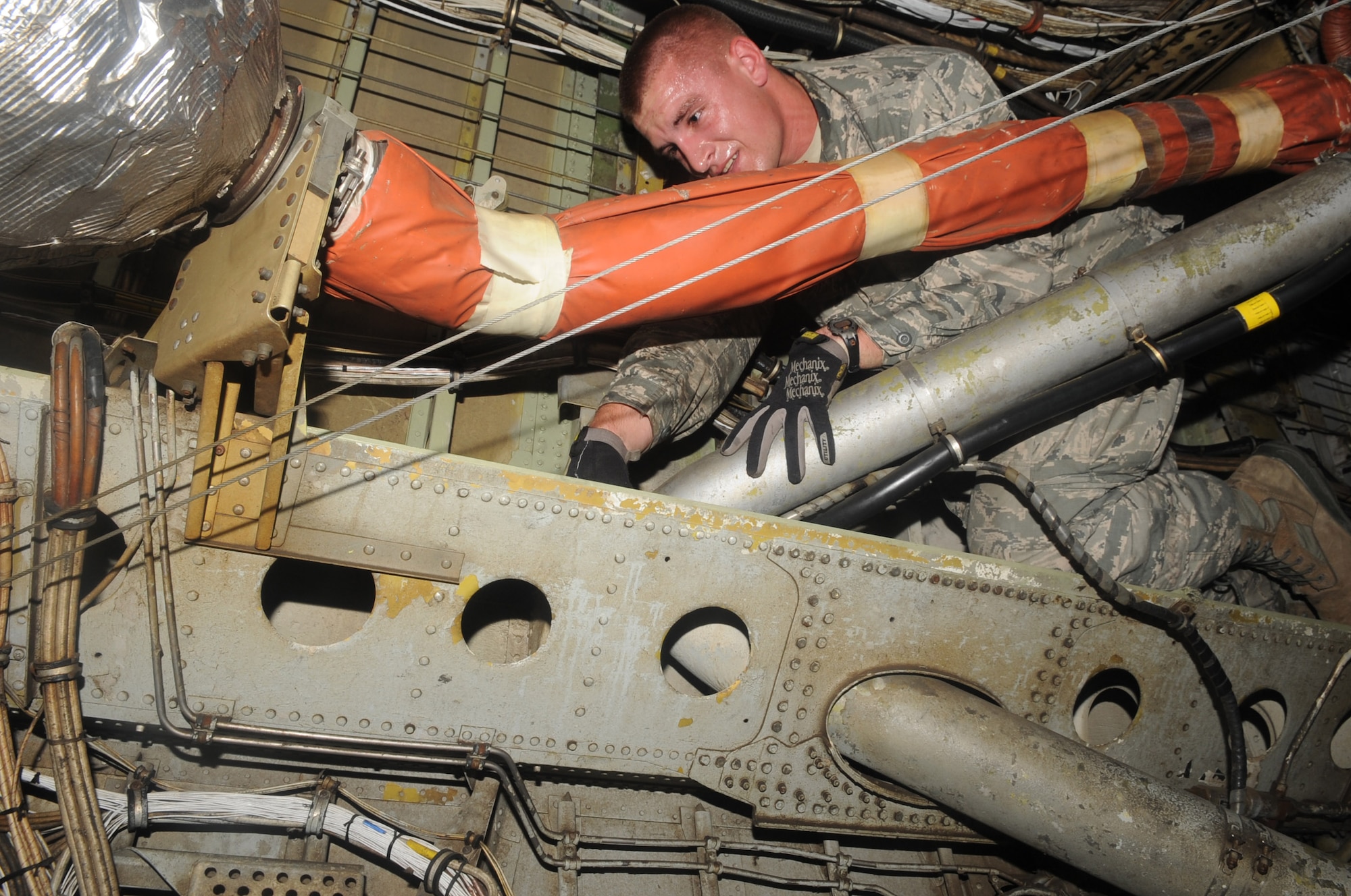 Airman 1st Class Nathan Weber, 2nd Civil Engineer Squadron Fire Department tail board, crawls through the bomb bay of a B-52H Stratofortress during egress training on Barksdale Air Force Base, La., Sept. 21. The bomb bay is used if the main entrance is not accessible during a fire or rescue mission. (U.S. Air Force photo/Senior Airman Kristin High)(RELEASED)