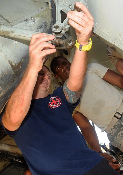 Adam Lynch, 2nd  Civil Engineer Squadron Fire Department fire chief, teaches Airman 1st Class Shelby Bonds, 2nd Civil Engineer Squadron Fire Department tail board, how to open the bomb bay doors of a B-52H Stratofortress during egress training on Barksdale Air Force Base, La., Sept. 21. The bomb bay is used as a back-up entry on the B-52H if all others are blocked. (U.S. Air Force photo/Senior Airman Kristin High)(RELEASED)