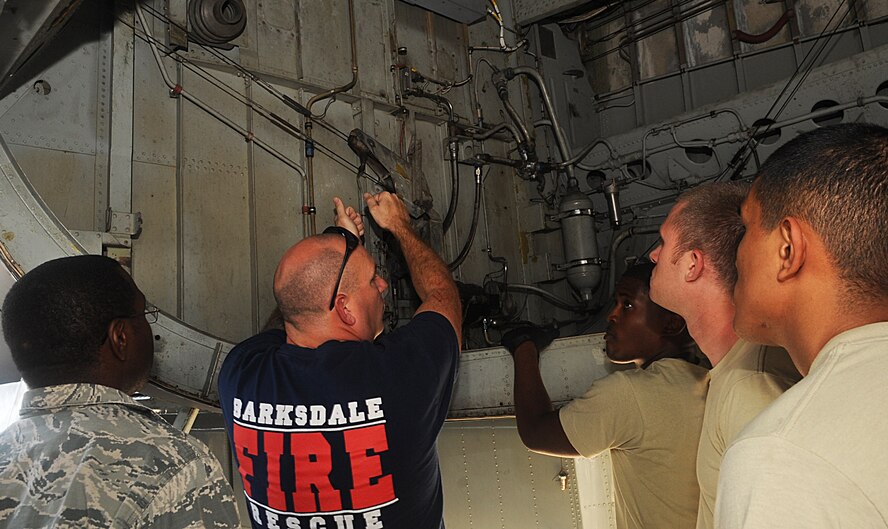 Adam Lynch, 2nd Civil Engineer Squadron Fire Department, demonstrates to coworkers, 2CES Fire Department, how to unlock the doors inside of a B-52H Stratofortress during egress training on Barksdale Air Force Base, La., Sept. 21. The bomb bay is used as a back-up entry into the B-52H if the other entries are blocked. (U.S. Air Force photo/Senior Airman Kristin High)(RELEASED)