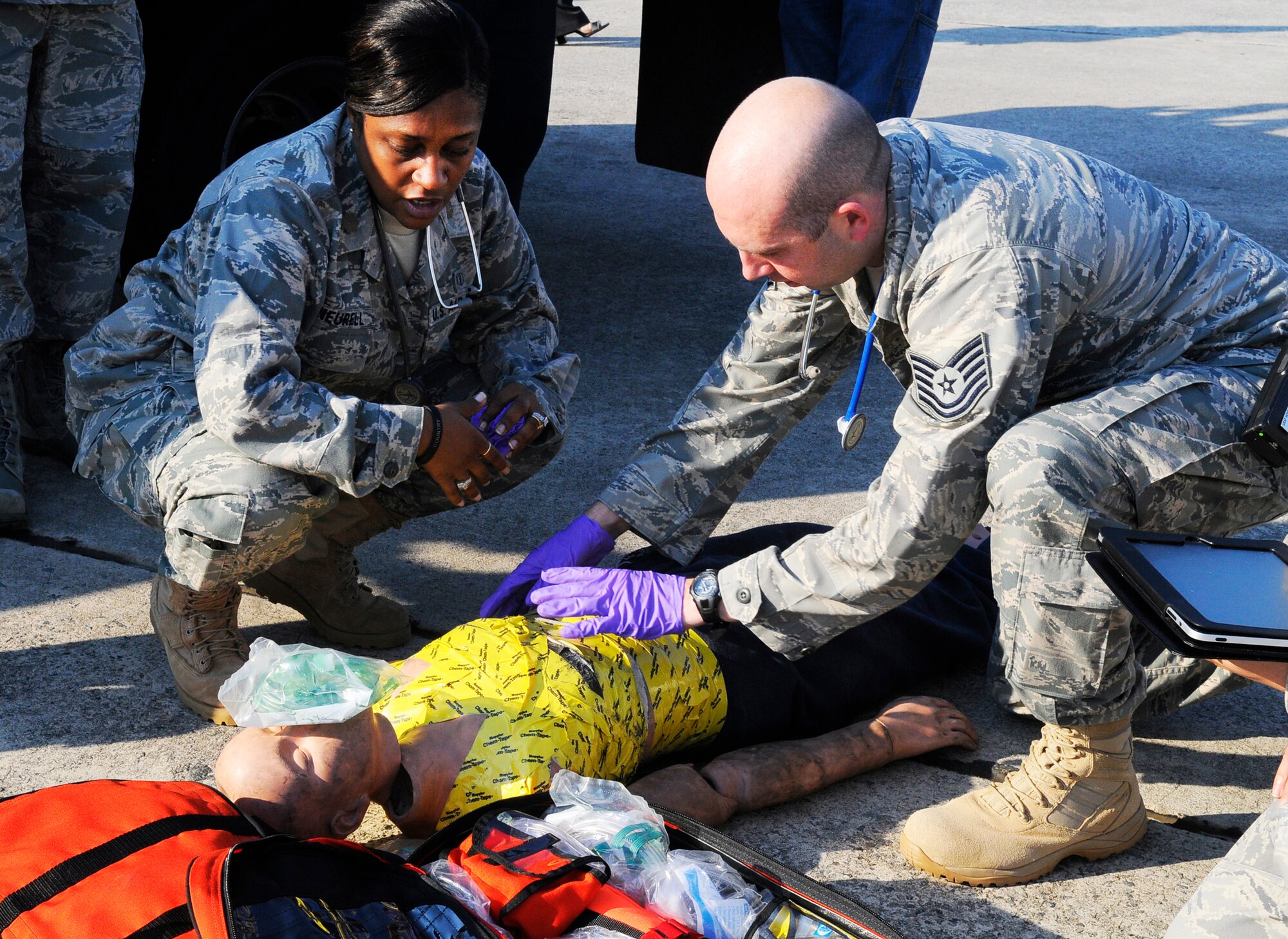 Major Mia Neurell and Tech. Sgt. Allan Pickren attend to a victim during the simulated C-130 egress exercise. U. S. Air Force photo by Sue Sapp