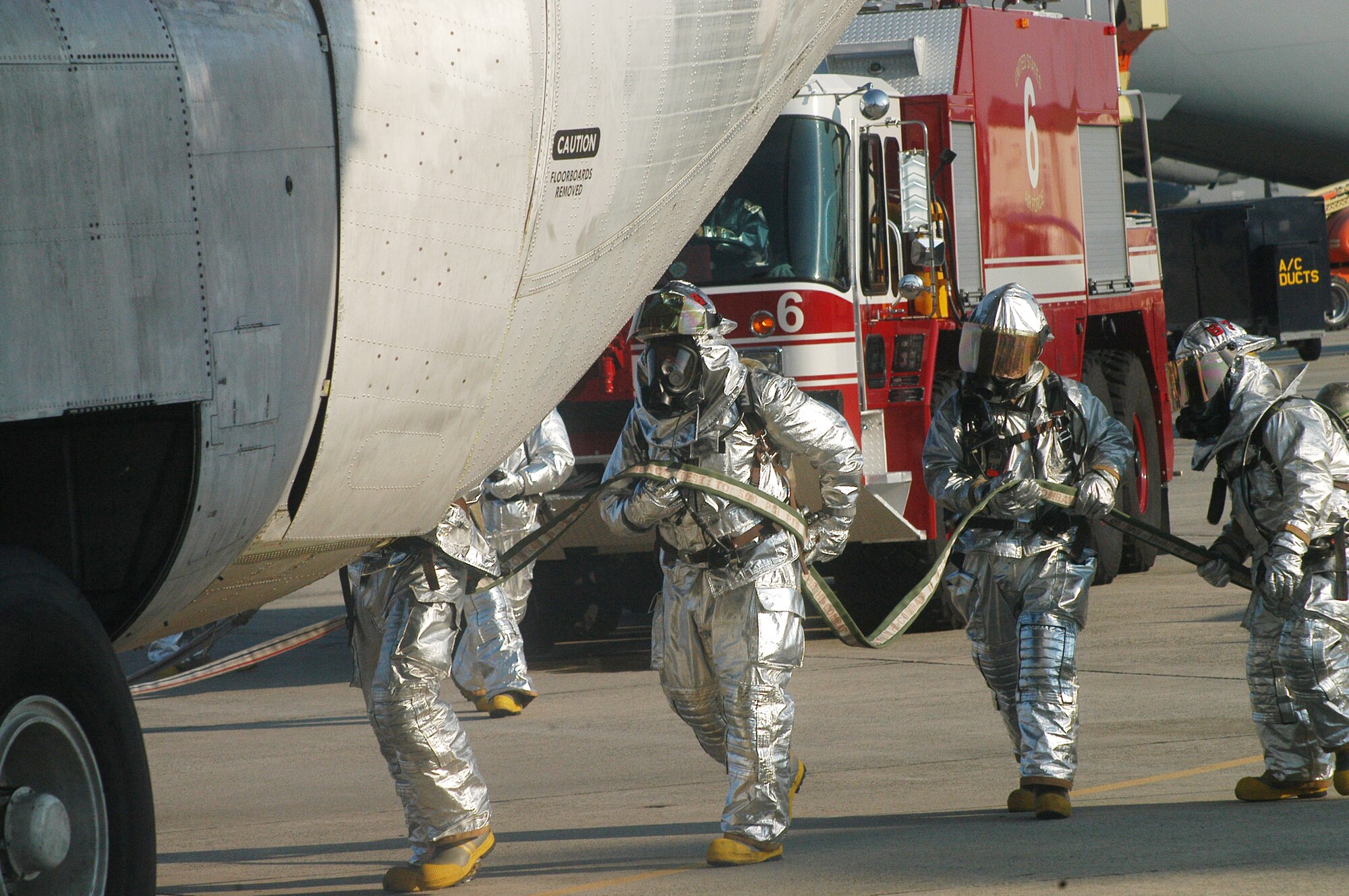 Robins firefighters respond during a flightline training scenario for a C-130 egress exercise. U. S. Air Force photo by Sue Sapp