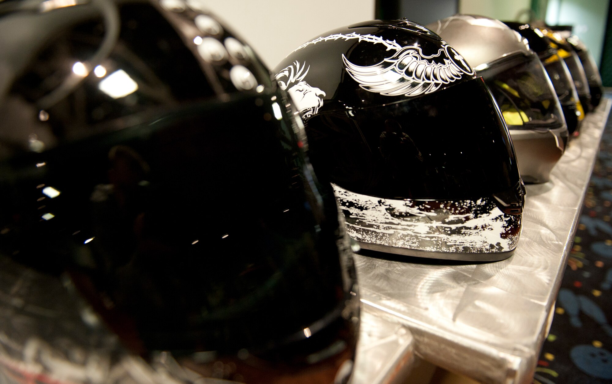 Helmets sit lined up from the Green Knights motorcycle club during a weekly meeting Sept. 23, 2011, at Incirlik Air Base, Turkey. The club was formed in late 1999 and were formally recognized in 2000 at Joint Base McGuire-Dix-Lakehurst, N.J. (U.S. Air Force photo by Senior Airman Anthony Sanchelli/Released)