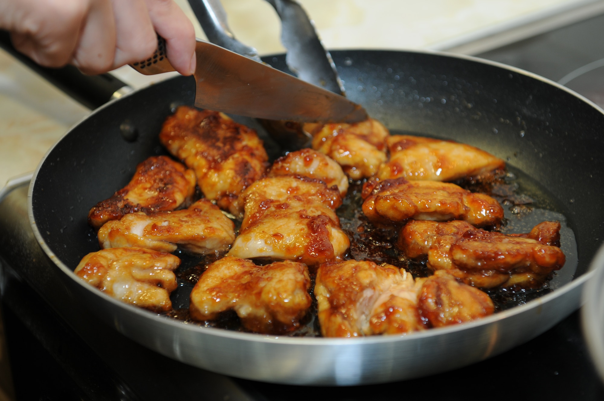ROYAL AIR FORCE LAKENHEATH, England - Maki Grupp, Sel et Poivre chef, prepares teriyaki chicken during a cooking class at the Airman and Family Readiness Center on Sept. 22, 2011.  The cooking class participants were taught to prepare teriyaki chicken along with cheese rolls.  The class is open to all Airmen and family members.  (U.S. Air Force photo by Airman Cory D. Payne)