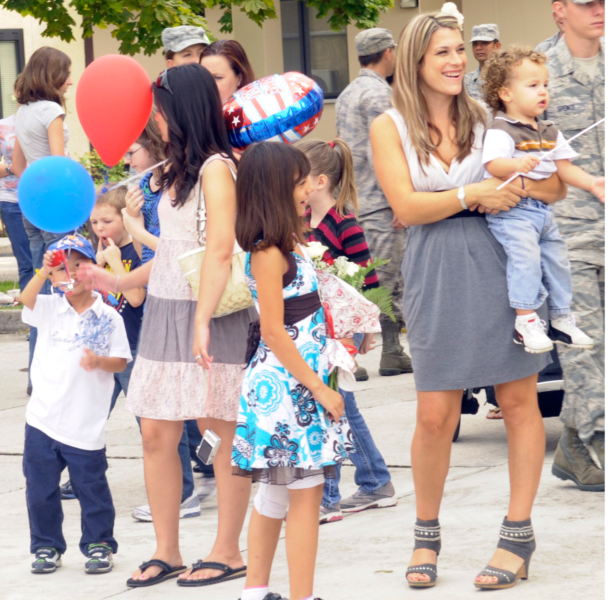 Family and friends eagerly wait for the return of 154 Airmen assigned to the 603rd Air Control Squadron from a six month long deployment. The Airmen were deployed to four different locations in Southwest Asia in support of Operation New Dawn. (U.S. Air Force photo/Airman 1st Class Briana Jones)