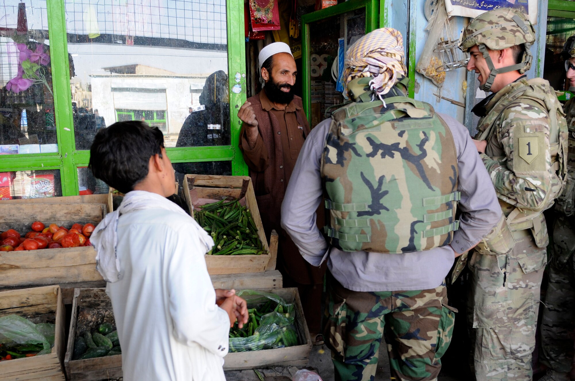 Capt.Tyler Johnson (right), Provincial Reconstruction Team Paktya engineer, talks with a local Afghan shop owner during a Ahmad Abad district market walk, Sept. 18, 2011. Johnson is a member of PRT Paktya, a team dedicated to partnering with the Afghan Government to work toward a secure, sustainable Afghanistan. (U.S. Air Force photo/Senior Airman Wesley Farnsworth) 
