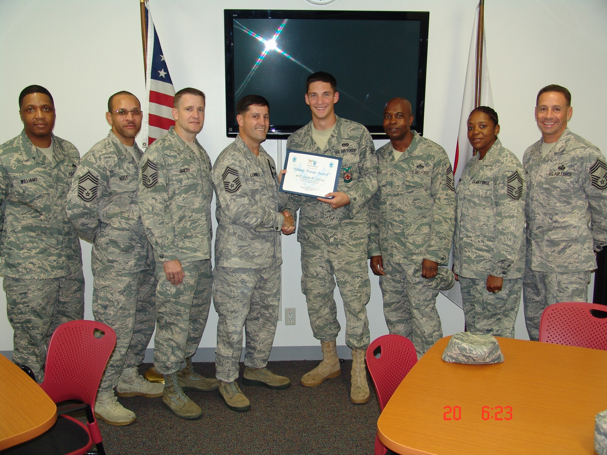 YOKOTA AIR BASE, Japan -- Chief master sergeants from the Yokota Chiefs' Group pose for a photo with Airman 1st Class Jacob R. Collins, 374th Civil Engineer Squadron firefighter, at Yokota Air Base, Japan, Sept. 20, 2011. Collins was selected to receive the Sharp Troop award for the month of August. Chief Master Sgt. Scott Smith, YCG member, said Collins was selected for his "outstanding contributions as a Yokota firefighter as well as for being a sharp, standout Airman who consistently portrays positive attributes for his fellow Airmen to emulate." (Courtesy photo/Senior Master Sgt. Kevin Riehle)