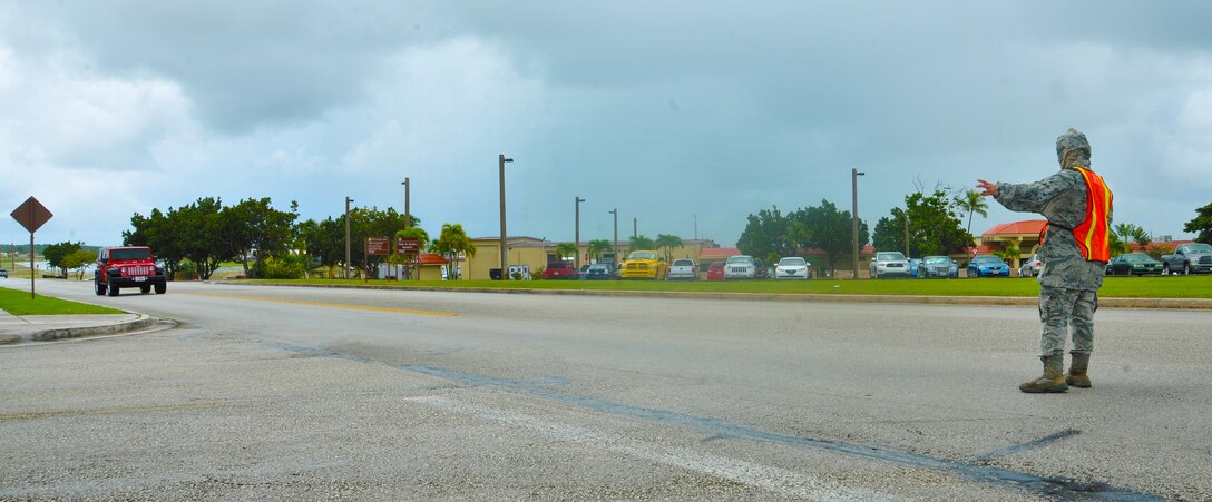 ANDERSEN AIR FORCE BASE, Guam—A 36th Security Forces Squadron member redirects traffic during disaster response exercise MARIANAS RUMBLE here, Sep. 21. A large portion of the flight line was inaccessible due to simulated damage, and it was the responsibility of security forces to ensure all traffic was diverted away from the damage. (U.S. Air Force photo by Senior Airman Benjamin Wiseman/Released)