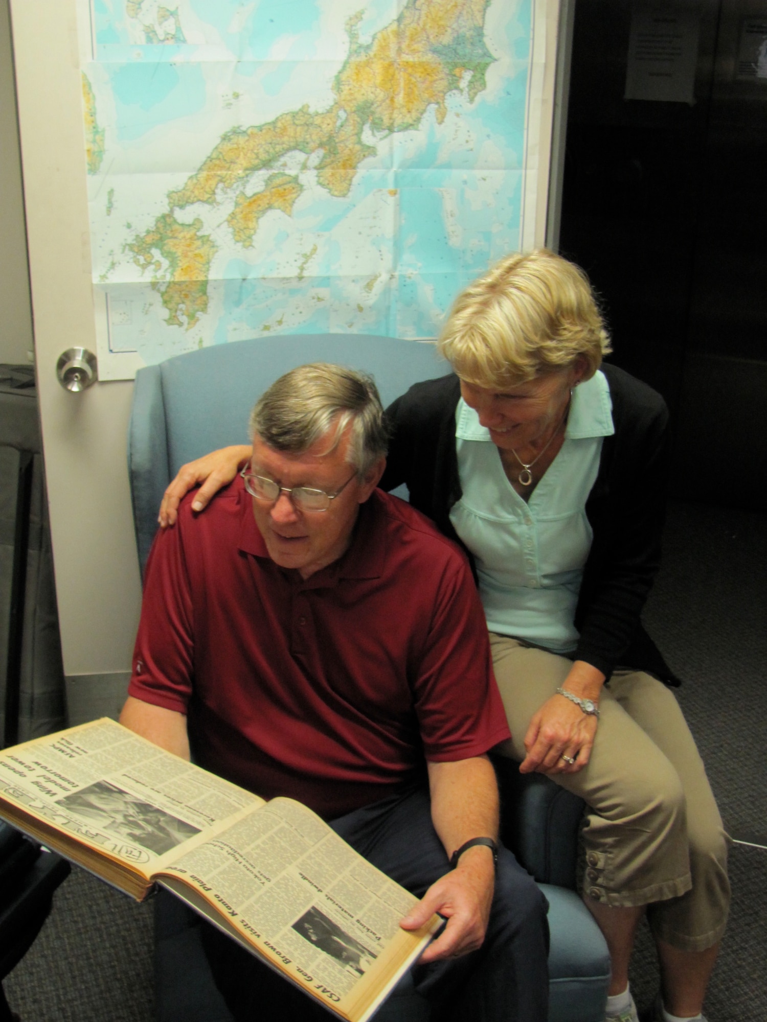 Tim Roberts and his wife, Margaret, take time to read through some old base newspapers here at Yokota, September 21, 2011. Mr. Roberts was stationed at Yokota as a dental officer from August 1973 to 1976. Mr.and Mrs. Roberts visited Yokota recently to take a trip down memory lane. (Courtesy photo/Dr. John Treiber)