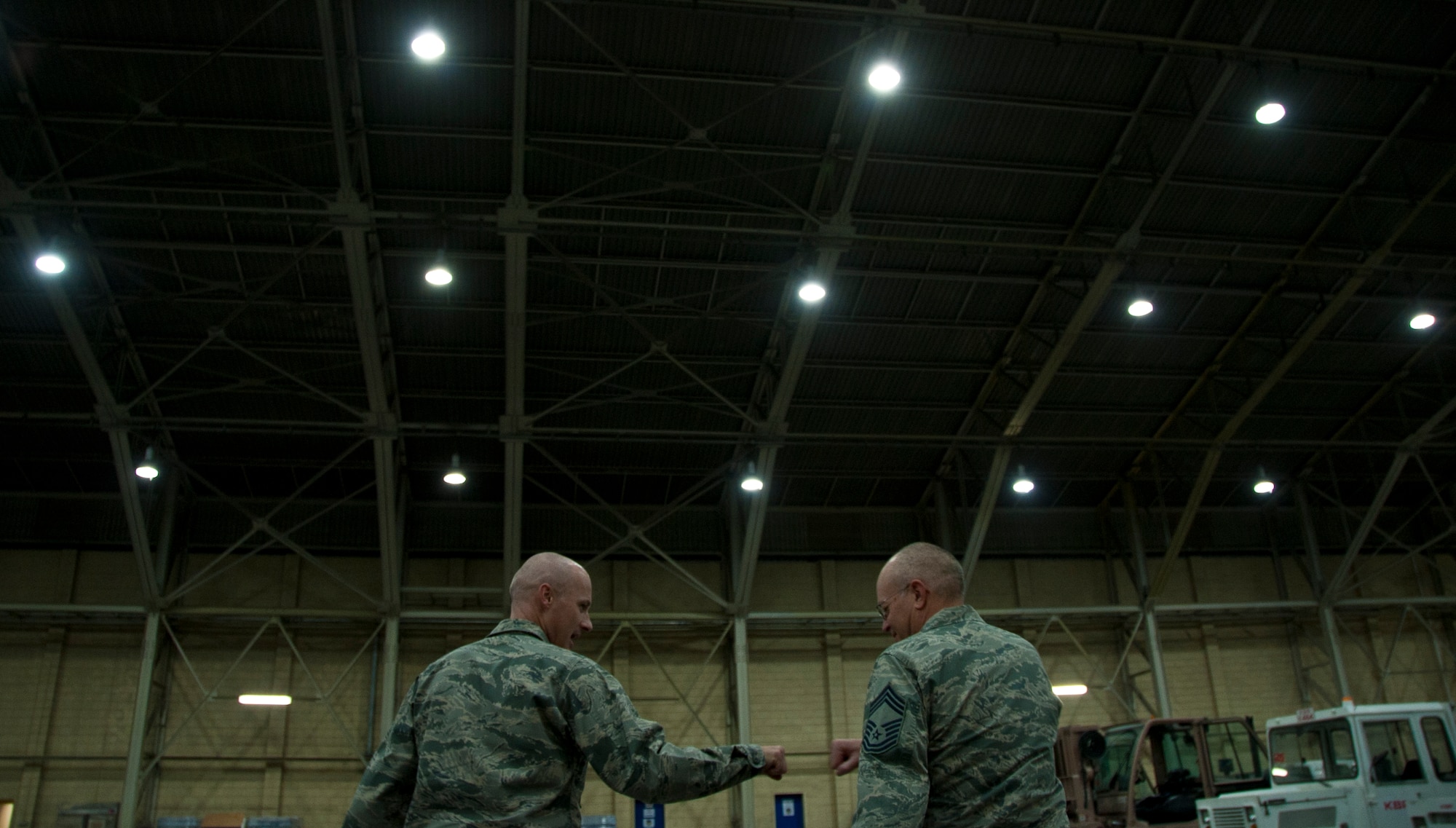 KANDAHAR AIRFIELD, Afghanistan -- Col. Samuel Grable, 451st Expeditionary Mission Support Group, and Chief Master Sgt. Glenn Doby, 451st EMSG superintendent, fist bump Sept. 18, 2011, after handing out cupcakes and cookies to members of the 451st Air Expeditionary Wing who could not attend the Air Force Birthday Bash at Camp Losano. Grable and Doby visited nine units and wished them a happy Air Force birthday.  (U.S. Air Force photo by Senior Airman David Carbajal)