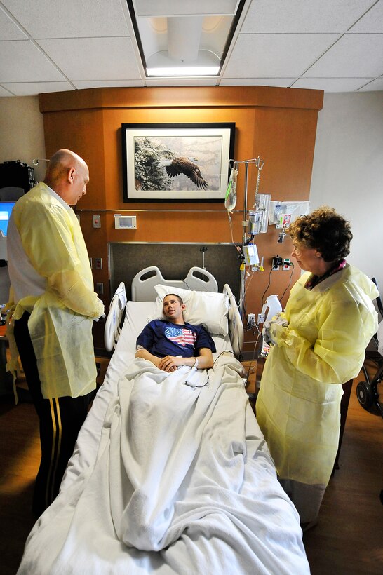 Army Chief of Staff Gen. Raymond T. Odierno and his wife, Linda, talk to Army Sgt. Justin Griffin, a wounded combat engineer, during a visit to the Walter Reed National Military Medical Center in Bethesda, Md., Sept. 22, 2011.