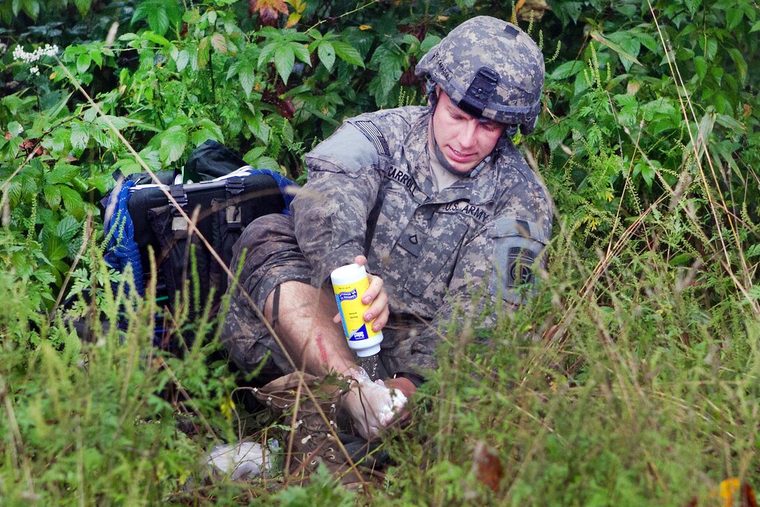 A paratrooper takes a break to powder his feet while on a long ruck march during a mountain training exercise on Camp Frank D. Merrill near Dahlonega, Ga., Sept. 21, 2011.
