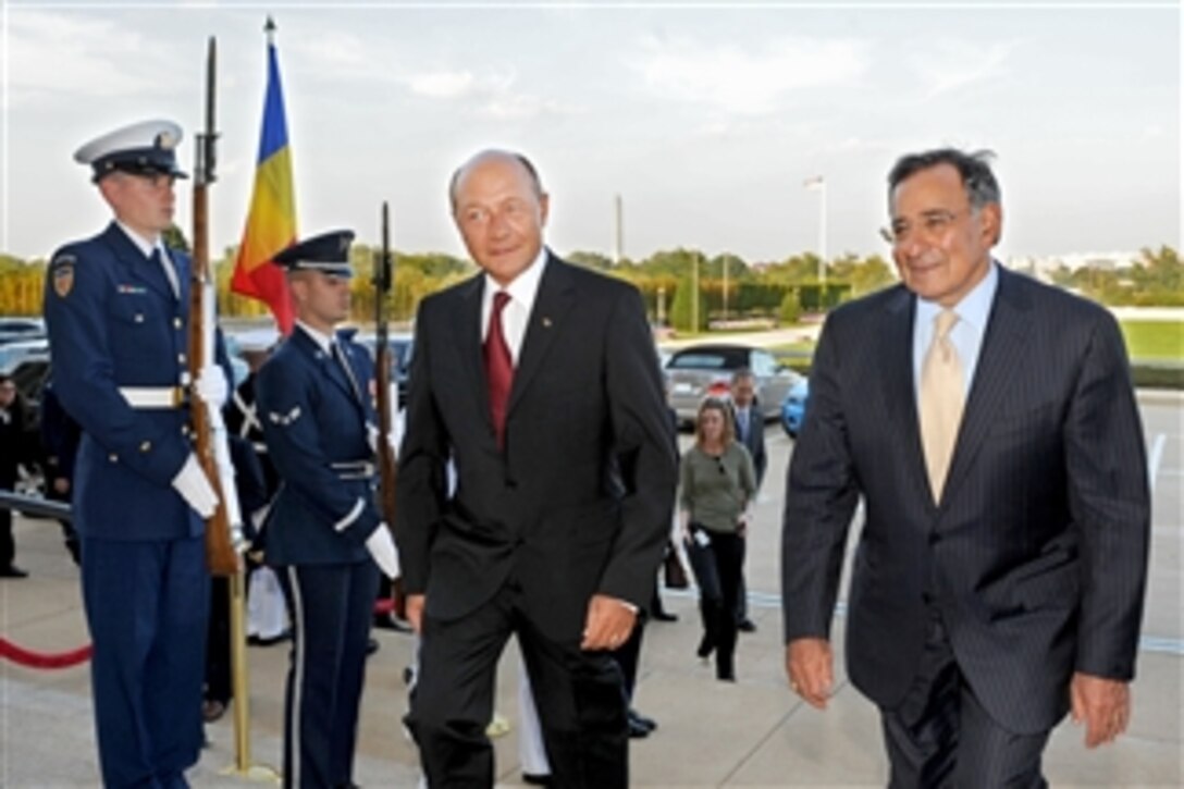 Secretary of Defense Leon E. Panetta (right) escorts Romanian President Traian Basecu (left) as he arrives at the Pentagon on Sept. 13, 2011.  The two men will hold bilateral security discussions on a variety of issues.  