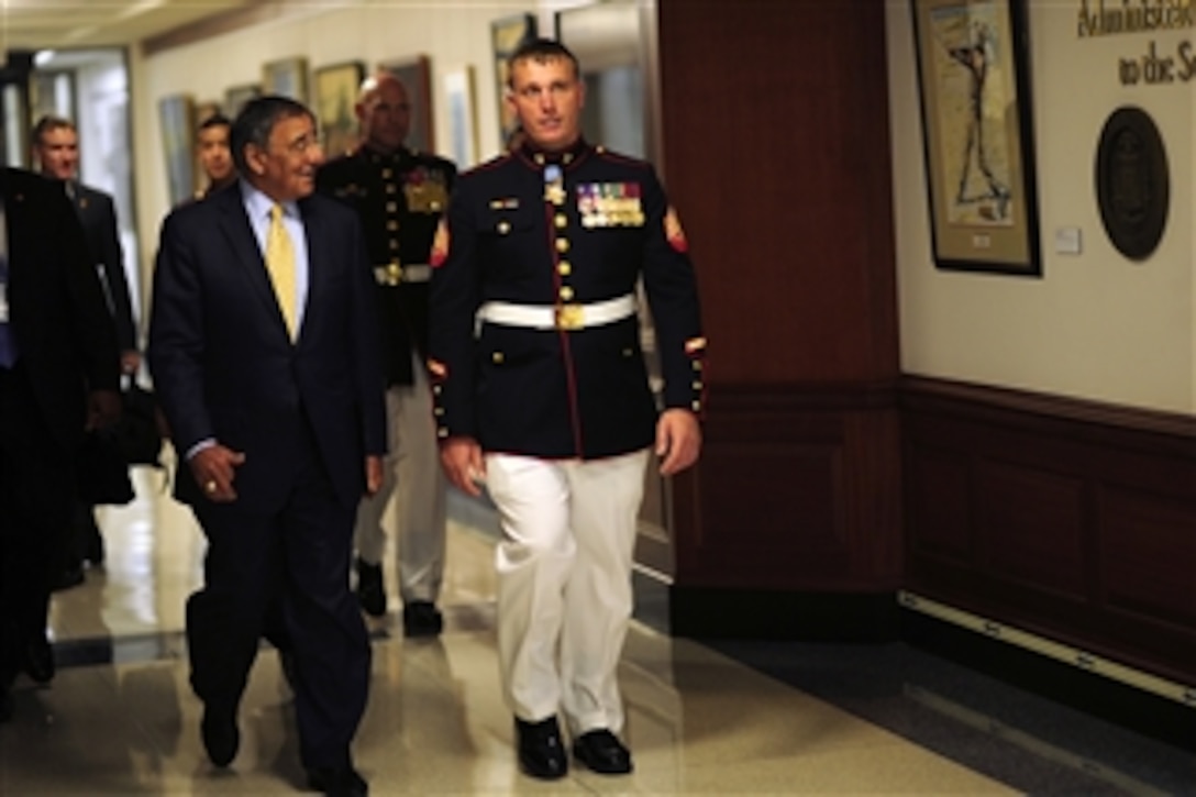 Secretary of Defense Leon Panetta escorts Medal of Honor recipient Marine Sgt. Dakota L. Meyer to the Hall of Heroes induction ceremony at the Pentagon in Arlington, Va., on Sept. 16, 2011.  Meyer was awarded the Medal of Honor by President Barack Obama in a White House ceremony the previous day.  