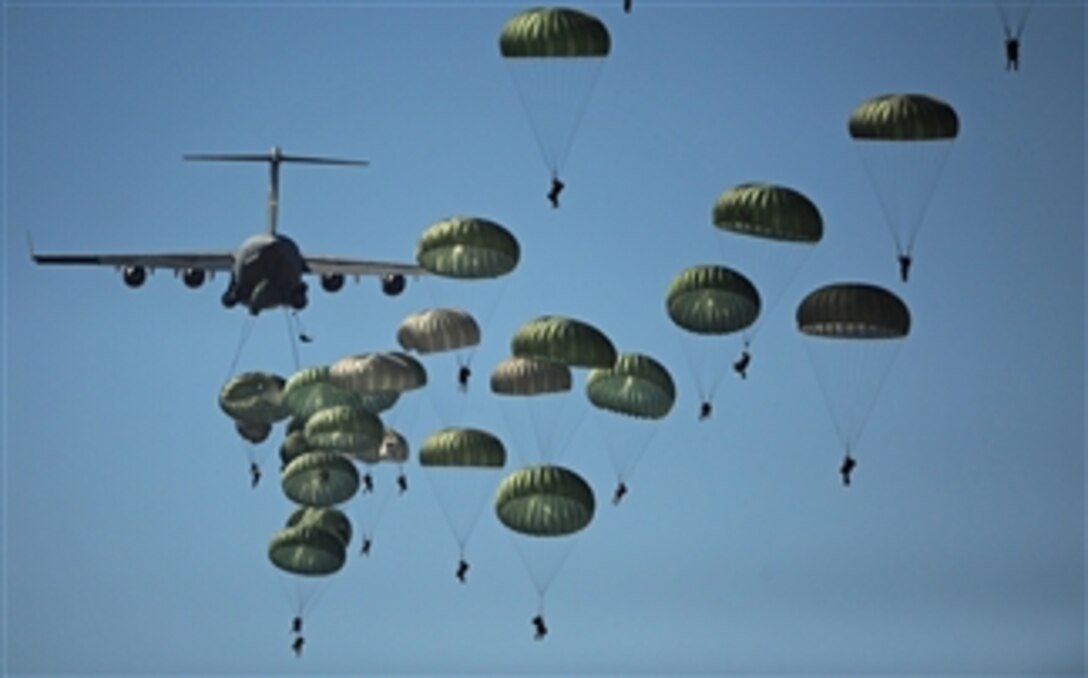 U.S. Army paratroopers from the 82nd Airborne Division descend to the ground after jumping out of a C-17 Globemaster III aircraft over drop zone Sicily during Joint Operations Access Exercise at Ft. Bragg, N.C., on Sept. 10, 2011.  The one-week exercise prepares the Air Force and the Army to respond to worldwide crises and contingencies.  