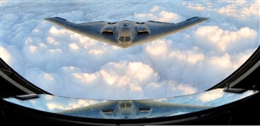 A B-2 Spirit bomber from the 509th Bomb Wing, Whiteman Air Force Base, Mo., approaches a tanker as both aircraft fly over Kansas on Sept. 9, 2011.  