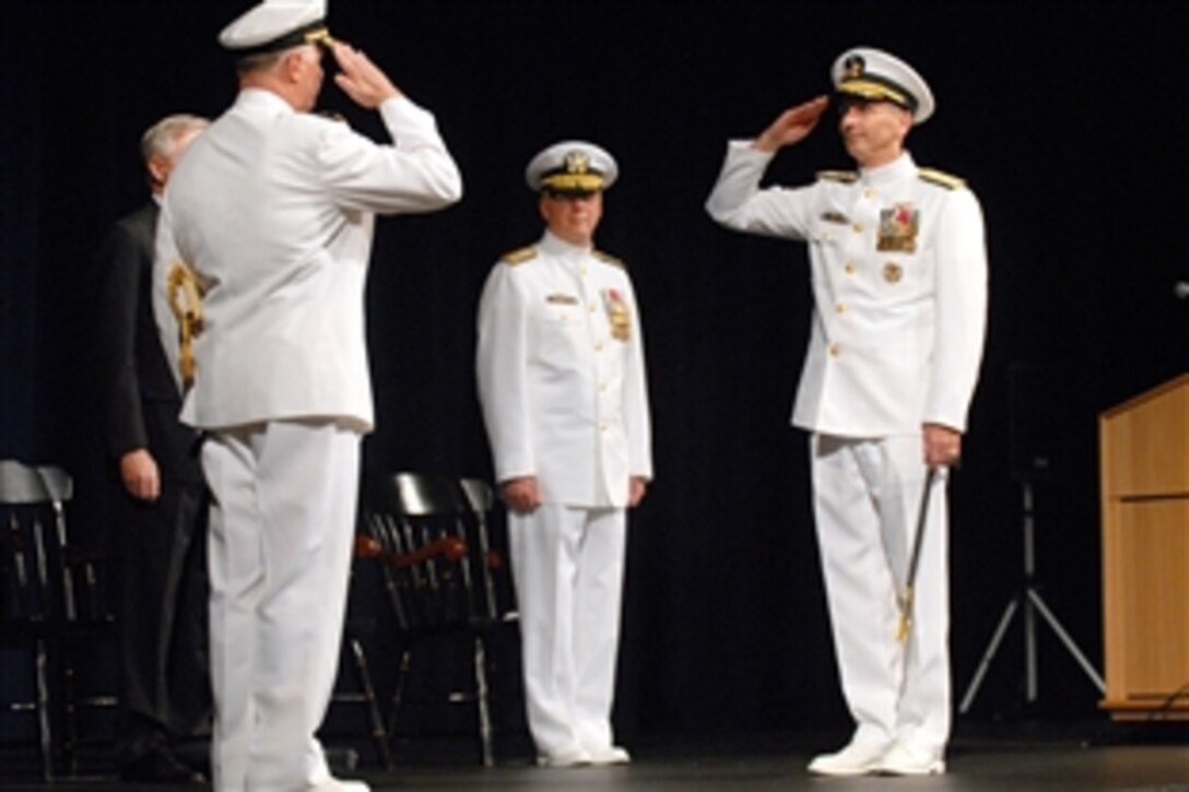 Chief of Naval Operations Navy Adm. Gary Roughead, left, offers a salute to the new Chief of Naval Operations Navy Adm. Jonathan Greenert, right, during a change-of-office ceremony held at the U.S. Naval Academy, Annapolis, Md., Sept. 23, 2011. Greenert became the 30th Chief of Naval Operations.