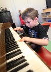 Nicholas Lowrey, son of Tech. Sgt. Susana Lowrey, 559th Aerospace Medicine Squadron, taps on piano keys Sept. 13 at the Lackland Youth Center. Nicholas is enrolled in the center’s School Age Program. (U.S. Air Force photo/Robbin Cresswell)