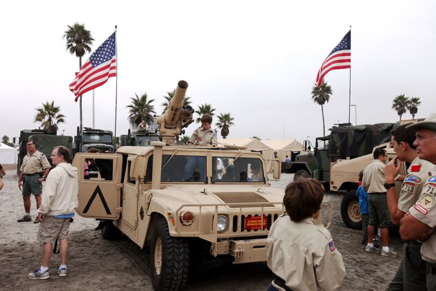 Citizens of Oceanside interact with a static display by Marines and sailors with 1st Marine Logistics Group in Oceanside, Calif., during the annual Harbor Days celebration, Sept. 25. The display allowed the visitors to learn about the equipment service members use overseas.