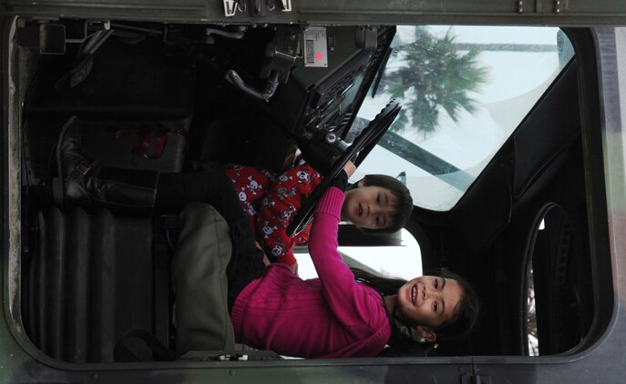 Children have fun playing inside a 7-ton truck during the Oceanside Harbor Days event in Oceanside, Calif., Sept. 25. The truck was among many other equipment displayed by Marines and sailors from 1st Marine Logistics Group, during the annual Harbor Days celebration.