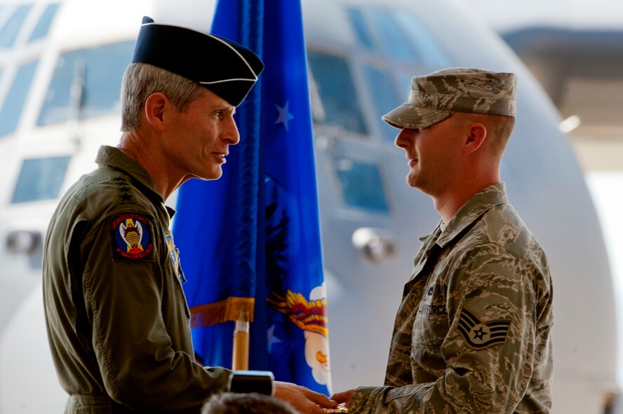U.S. Air Force General Norton A. Schwartz, Chief of Staff of the U.S. Air Force, hands over the ceremonial key to U.S. Air Force Staff Sgt. Christopher Meyer, a crew chief with the 563rd Rescue Group at the HC-130 J arrival ceremony at Davis-Monthan Air Force Base, Az. on Sept. 24, 2011. Meyer will be the dedicated crew chief to the HC-130J Combat King II. (U.S. Air Force photo by Staff Sgt. Joshua J. Garcia/Released)