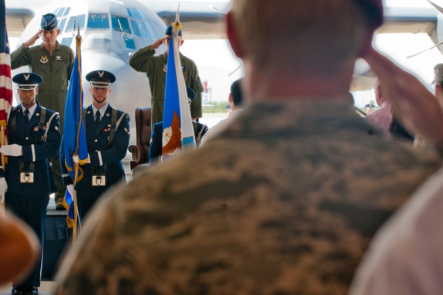 U.S. Air Force Chief of Staff Gen. Norton Schwartz,and members from Davis-Monthan Air Force Base, Az., salute the flag during the singing of the national anthem at the HC-130J arrival ceremony held on base, Sept. 24, 2011. The ceremony commemorated the arrival of the first HC-130J Combat King II to the base, which will replace the current HC-130P/Ns aircraft. (U.S.Air Force photo by Staff Sgt. Joshua J. Garcia/Released)