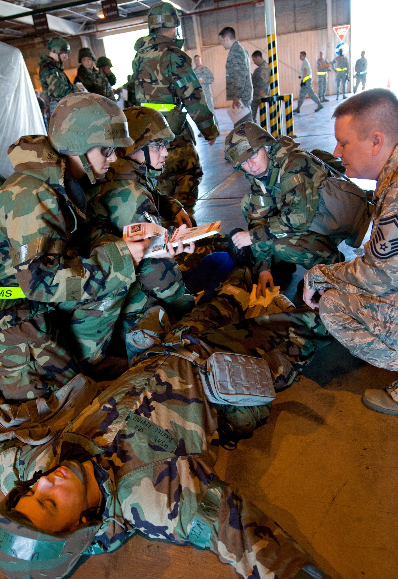 YOKOTA AIR BASE, Japan -- Airmen from the 730th Air Mobility Squadron are evaluated on their Self Aid and Buddy Care skills during a mission capability and compliance inspection at Yokota Air Base, Japan, Sept. 22, 2011. SABC skills are taught to all Airmen so they are able to provide basic life and limb-saving techniques on themselves and other injured personnel until medical personnel are available to continue care. (U.S. Air Force photo/Airman 1st Class Krystal M. Garrett) 