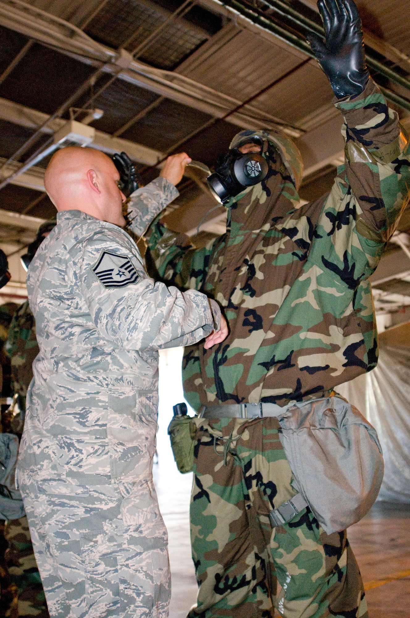 YOKOTA AIR BASE, Japan -- An inspector from the Air Mobility Command Inspector General Office examines the individual protective equipment of Tech. Sgt. Andre Thomas, 730th Air Mobility Squadron section chief, during a mission capability and compliance inspection at Yokota Air Base, Japan, Sept. 22, 2011.  The IG team travels from base to base inspecting units on their mission capability and compliance with Air Force regulations. (U.S. Air Force photo/Airman 1st Class Krystal M. Garrett)