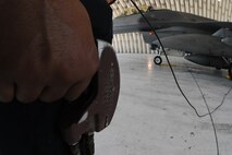 KUNSAN AIR BASE, Republic of Korea -- A crew chief from the 8th Aircraft Maintenance Squadron holds the dead man switch during a hot pit refuel here Sept. 21. The dead man switch starts and stops the fuel flow during a refuel. (U.S. Air Force photo/Senior Airman Brittany Y. Bateman)