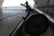 KUNSAN AIR BASE, Republic of Korea -- Senior Airman Miguel Valencia, 8th Logistics Readiness Squadron fuels distribution operator, pulls the pantograph back after performing a hot pit refuel here Sept. 21. A pantograph is a pipe system used to refuel aircraft during a hot pit refuels. (U.S. Air Force photo/Senior Airman Brittany Y. Bateman)