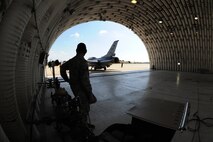 KUNSAN AIR BASE, Republic of Korea -- Senior Airman Miguel Valencia, 8th Logistics Readiness Squadron fuels distribution operator, watches as an F-16 Fighting Falcon taxis off after a hot pit refuel and waits for the next to arrive here Sept. 21. Hot pit refueling is a procedure usually performed in a combat situation to rapidly refuel aircraft. (U.S. Air Force photo/Senior Airman Brittany Y. Bateman)