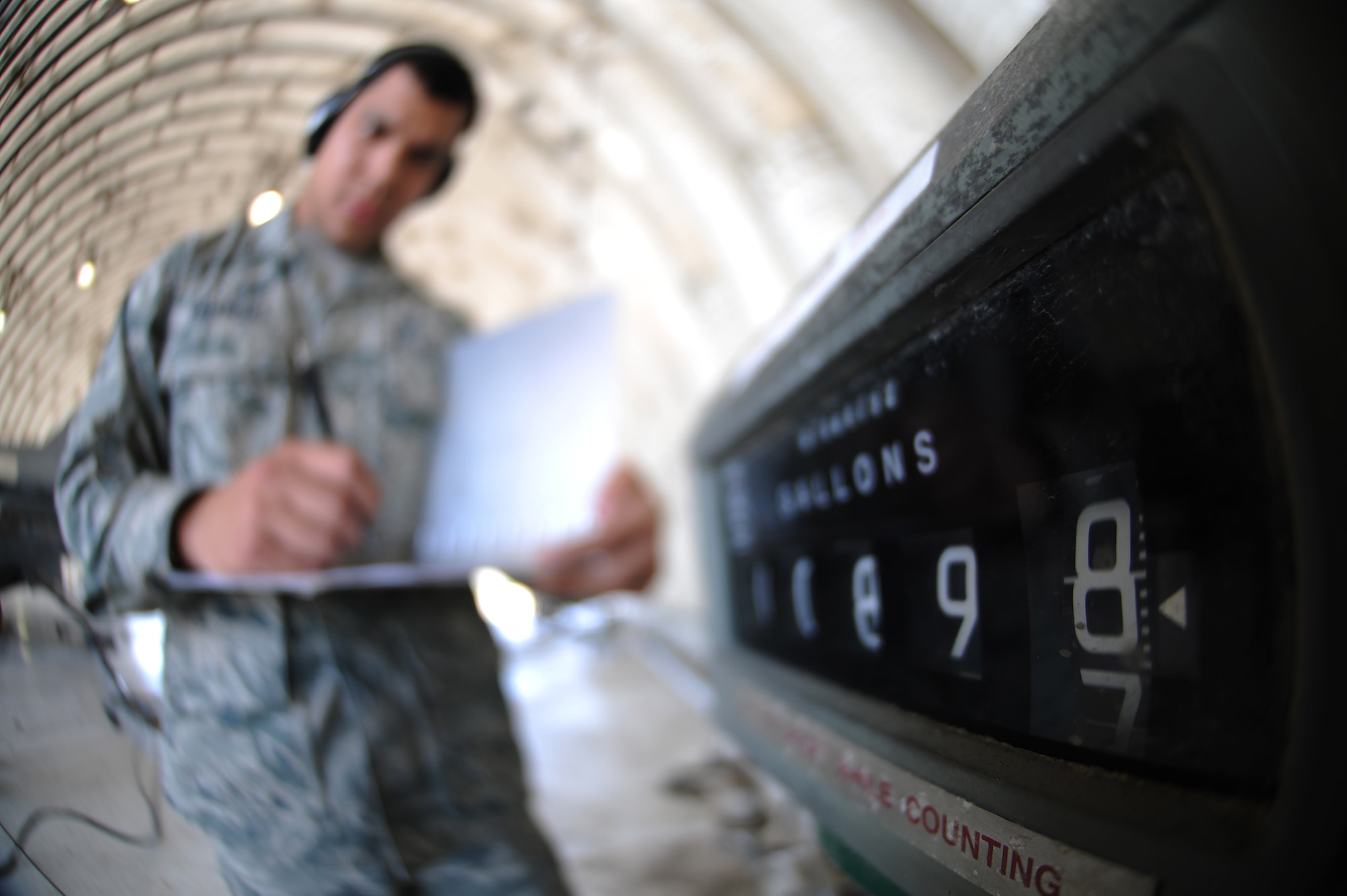 KUNSAN AIR BASE, Republic of Korea -- Senior Airman Miguel Valencia, 8th Logistics Readiness Squadron fuels distribution operator, writes down the number of gallons put into an F-16 Fighting Falcon during a hot pit refuel here Sept. 21. Hot pit refueling is a procedure usually performed in a combat situation to rapidly refuel aircraft. (U.S. Air Force photo/Senior Airman Brittany Y. Bateman)

