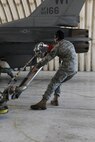 KUNSAN AIR BASE, Republic of Korea -- Senior Airman Miguel Valencia, 8th Logistics Readiness Squadron fuels distribution operator, pulls the pantograph toward an F-16 Fighting Falcon here Sept. 21. A pantograph is a pipe system used to refuel aircraft during a hot pit refuels. (U.S. Air Force photo/Senior Airman Brittany Y. Bateman)