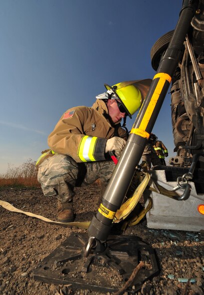 Airman 1st Class Paul Smith, 92nd Civil Engineer Squadron, uses a vehicle stabilization kit to keep a vehicle from rolling over during a extrication exercise Sept. 14 at Fairchild. They continually train for this in case they are needed to extricate a victim from a vehicle on base. (U.S. Air Force Photo/Staff Sgt. Michael Means)