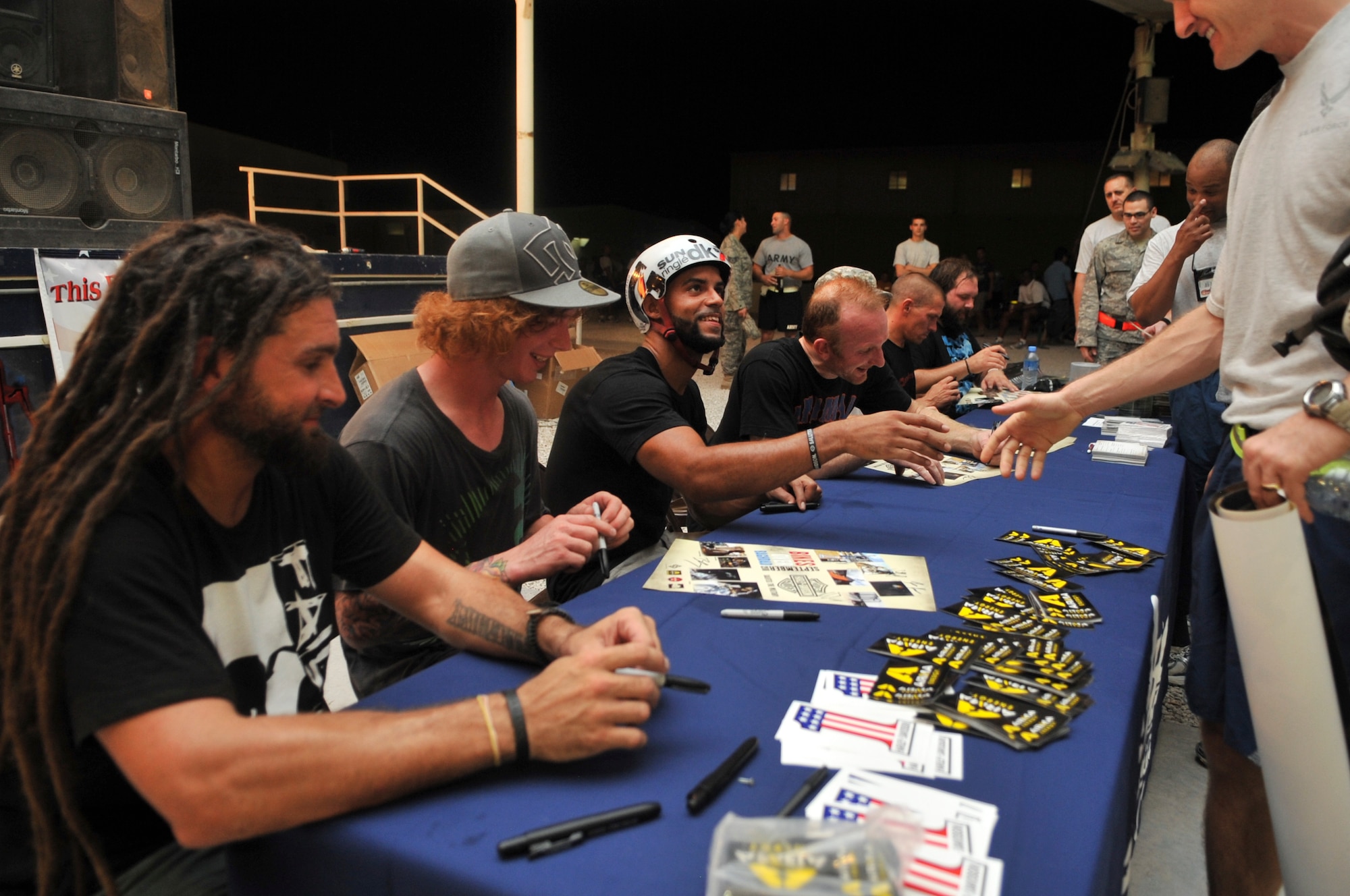 Bicycle motocross riders with the “Bikes over Baghdad” tour sign autographs after a performance for deployed servicemembers, Sept. 24, 2011, at an undisclosed location in Southwest Asia. (U.S. Air Force photo/Senior Airman Paul Labbe)