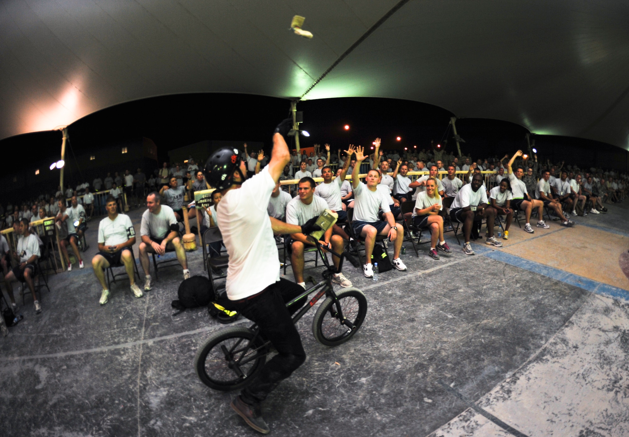 Brian Kachinsky throws a souvenir into the crowd during the “Bikes over Baghdad” event, Sept. 24, 2011, at an undisclosed location in Southwest Asia. (U.S. Air Force photo/Senior Airman Paul Labbe)