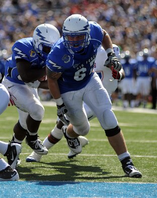 Air Force lineman Jordan Eason leads the way for running back Asher Clark on his way to a 7-yard touchdown run against the Tennessee State Tigers Saturday, Sept. 24, 2011 at Falcon Stadium. Clark finished with 148 yards rushing on 13 carries. The Falcons finished with 792 yards of offense on the day, a school and Mountain West record.  They beat the Tigers 63-24. (U.S. Air Force photo/Tech. Sgt. Raymond Hoy)