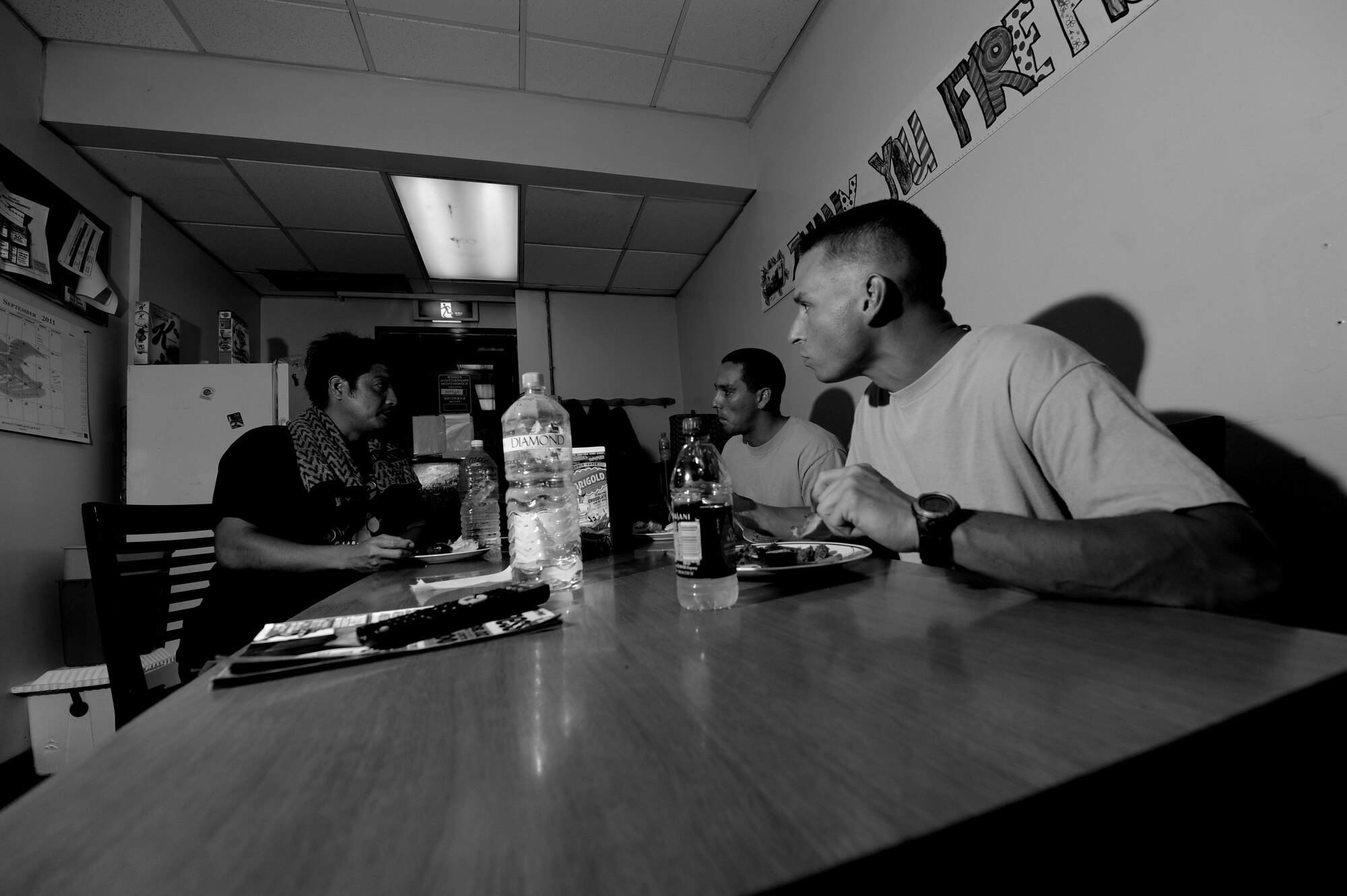 18th Civil Engineer Squadron firemen eat dinner at fire Station 1 on Kadena Air Base, Japan, Sept. 21.  Due to working 24-hour shifts, firemen regularly eat dinner together.  (U.S. Air Force photo/Airman 1st Class Jarvie Z. Wallace)
