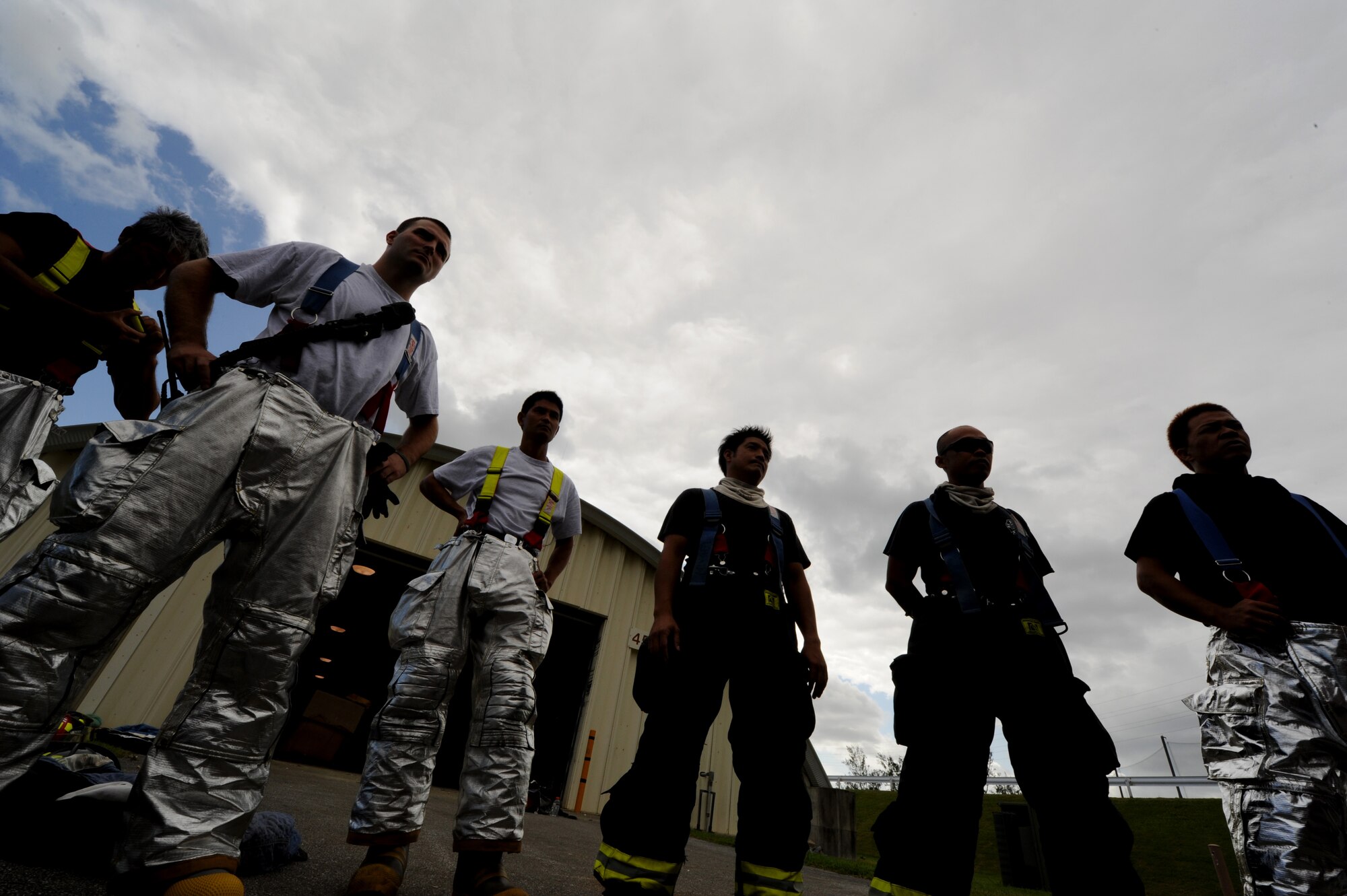 18th Civil Engineer Squadron firemen gather for a briefing prior to partaking in a live-fire structural training exercise on Kadena Air Base, Japan, Sept. 21. Live-fire structural training is an annual certification requirement for firemen where they are trained to extinguish live fire using tactical techniques of rescue, attack, and ventilation under live-fire conditions. (U.S. Air Force photo/Airman 1st Class Jarvie Z. Wallace)
