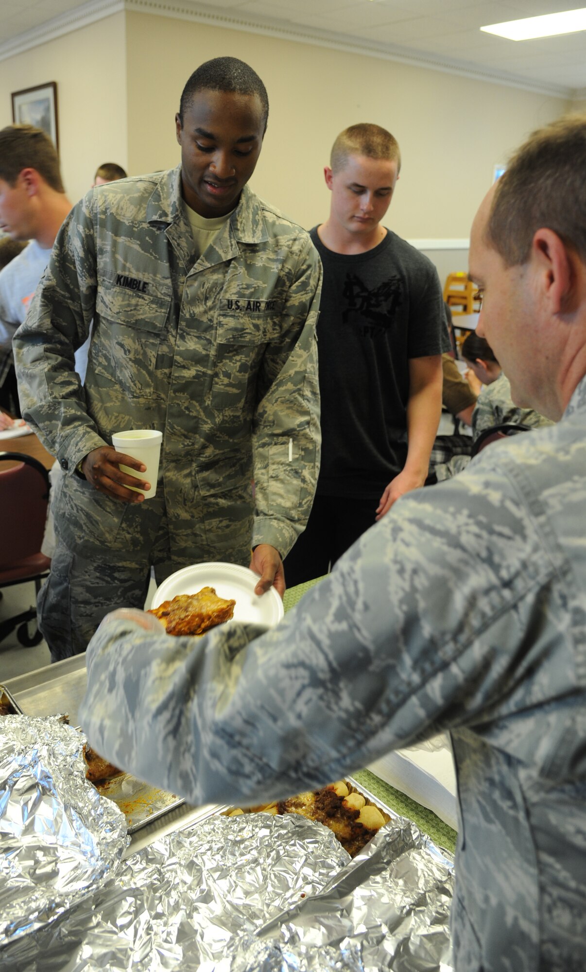 Airman 1st Class Lloyd Kimble, 14th Medical Operations Squadron, gets a helping of enchiladas at the Hispanic themed Dorm Dinner on Sept. 22. Dorm dinners bring together single enlisted Airmen living in the dormitories for food and mentoring. (U.S. Air Force photo/Airman 1st Class Chase Hedrick)