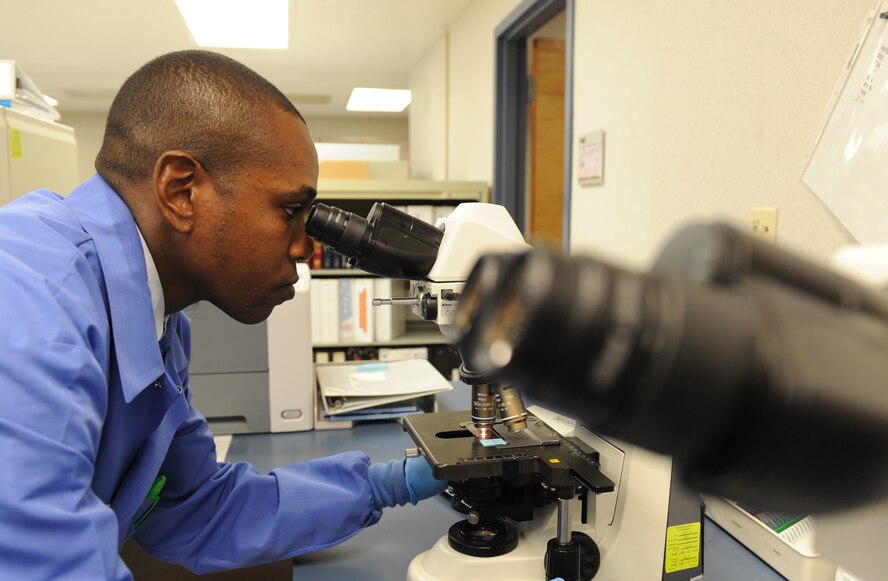 Staff Sgt. Terrence Raybon, 2nd Medical Support Squadron, looks through a microscope to find abnormalities in blood cells on Barksdale Air Force Base, La., Sept 26. The microscope has two sets of eyepieces to allow another person to view the same sample. (U.S. Air Force photo/Airman 1st Class Micaiah Anthony)(RELEASED)  