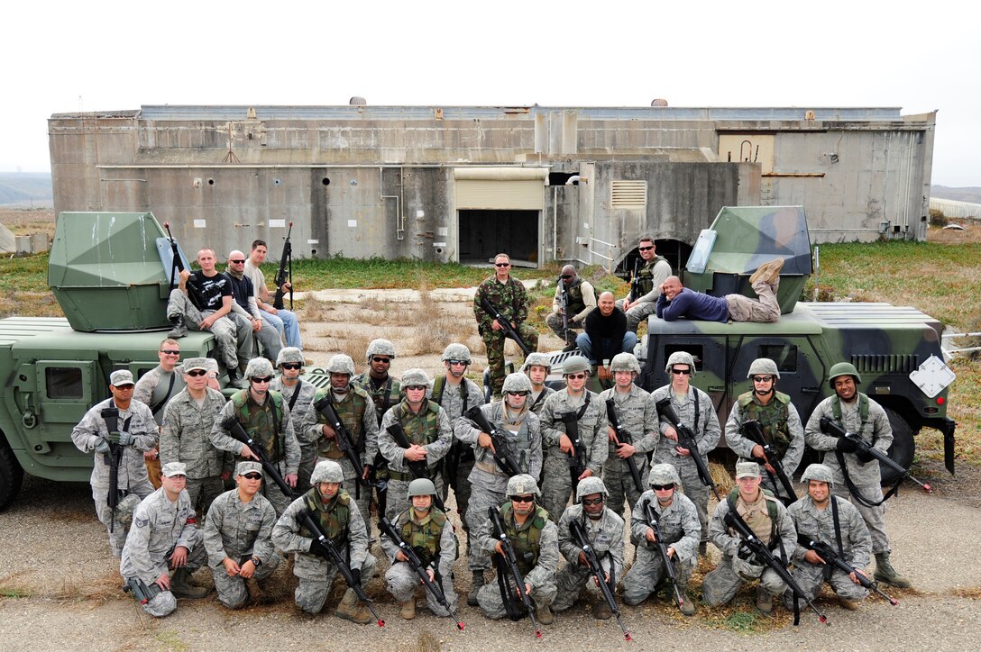 VANDENBERG AIR FORCE BASE, Calif. - Everyone involved in the civil engineer convoy exercise pose for a group photo after completing an exercise designed to simulate an actual deployment situation here Thursday, Sept. 22, 2011. The exercise was meant to mimic various scenarios likely to be encountered by deployed Airmen of the CES career field in hostile environments while on conveys overseas. (U.S. Air Force photo/Senior Airman Lael Huss)