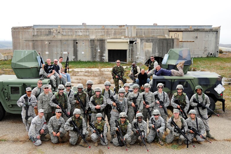 VANDENBERG AIR FORCE BASE, Calif. - Everyone involved in the civil engineer convoy exercise pose for a group photo after completing an exercise designed to simulate an actual deployment situation here Thursday, Sept. 22, 2011. The exercise was meant to mimic various scenarios likely to be encountered by deployed Airmen of the CES career field in hostile environments while on conveys overseas. (U.S. Air Force photo/Senior Airman Lael Huss)