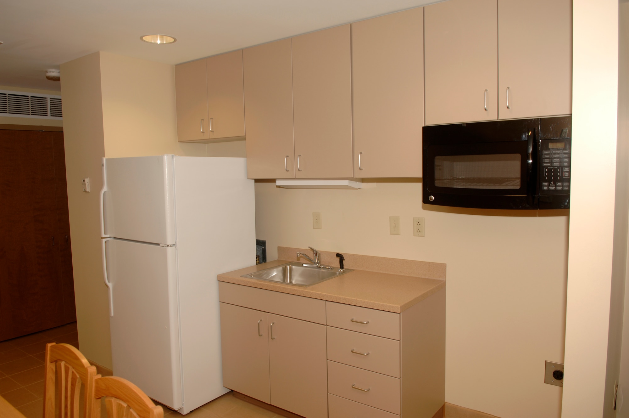 This image displays a view of the common area in the newest dorms at Shaw Air Force Base, S.C., Sept. 26, 2011. The new dorms are an apartment-like living area with a common room shared by four Airmen. Each individual Airman will have their own bathroom. (U.S. Air Force photo by Airman First Class Hunter Brady/Released)