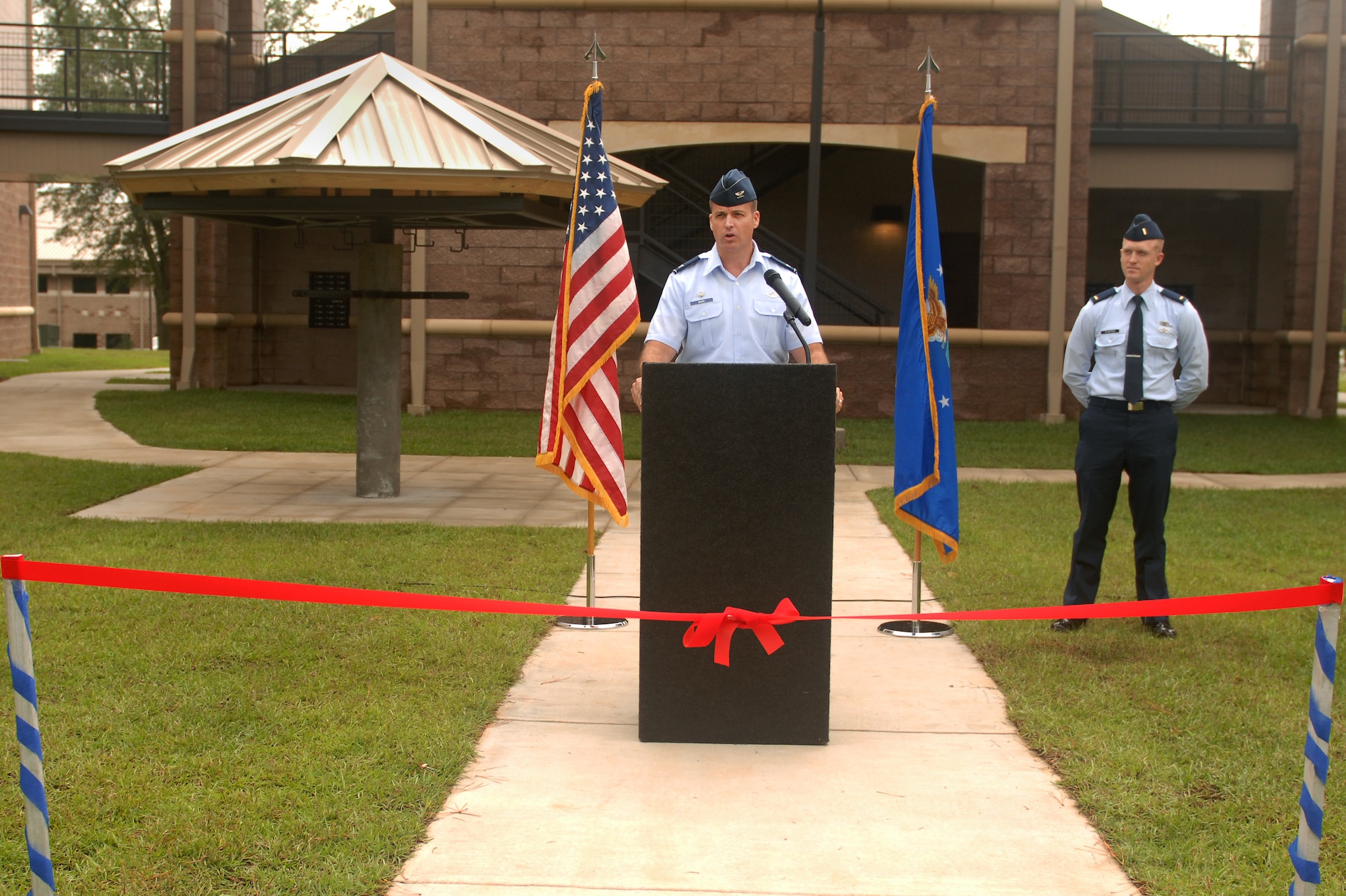 U.S. Air Force Col. Charlie Moore, 20th Fighter Wing commander speaks at the opening of Shaw’s newest dormitory, Sept. 26, 2011, Shaw Air Force Base, S.C. Each unit is a four bedroom apartment giving Airmen a private room, private bath, a shared kitchen and common area. (U.S. Air Force photo by Airman 1st Class Ashley L. Gardner/ Released)