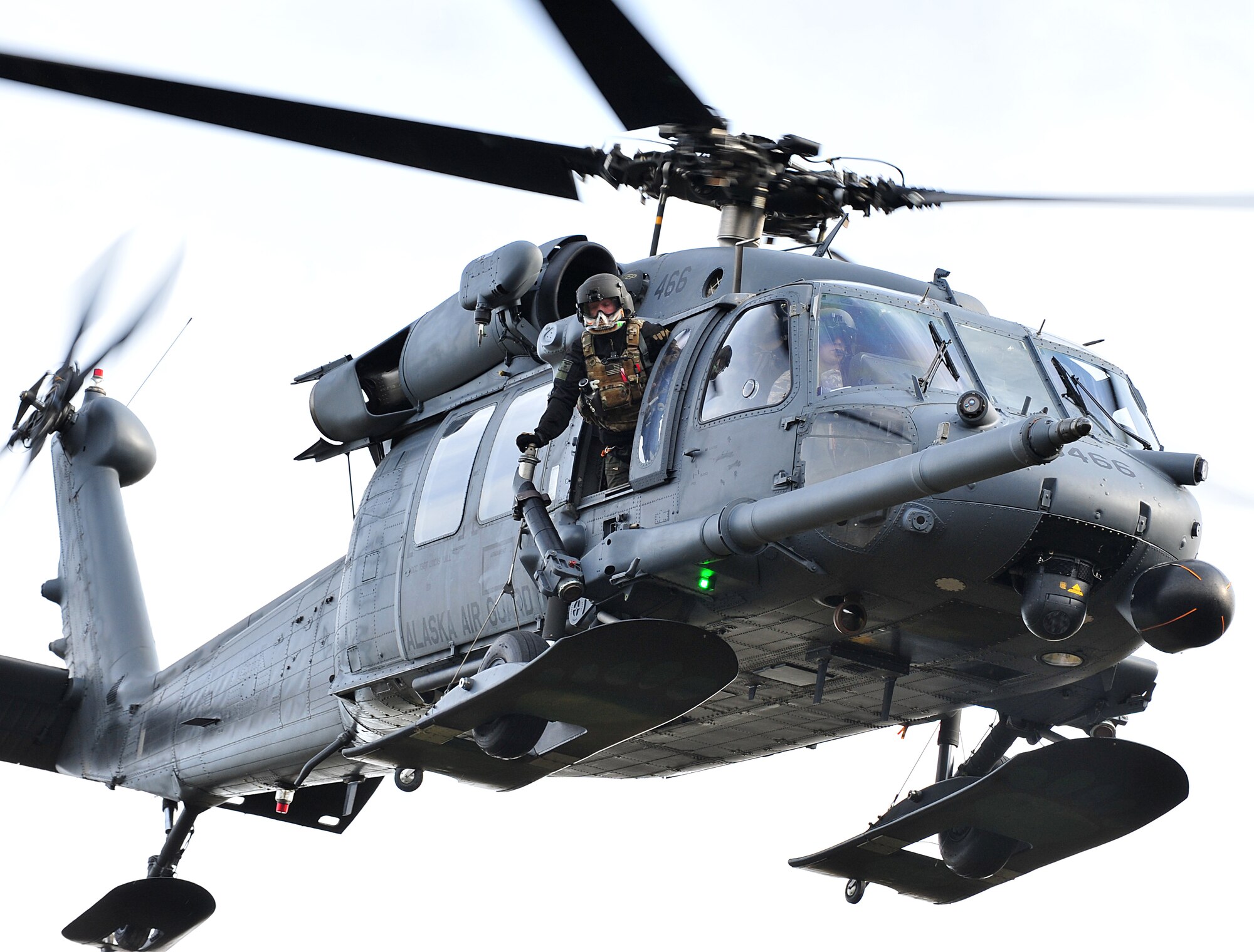An HH-60G Pavehawk helicopter transports the casualties and members of Baker Company, 3rd Battalion (Airborne), 509th Infantry Regiment and the 212th Rescue Squadron pararescuemen during training on Joint Base Elmendorf-Richardson September 21, 2011.  In this specific training scenario, the pararescuemen used the helicopter to evacuate members of Baker Company who were hit by an improvised explosive device.  (U.S. Air Force photo/Staff Sgt. Zachary Wolf)  